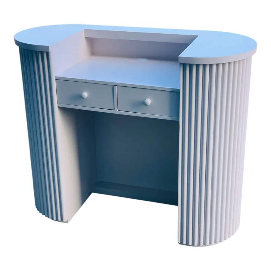 Rear of a blue reception desk showing the drawer bank and work surface