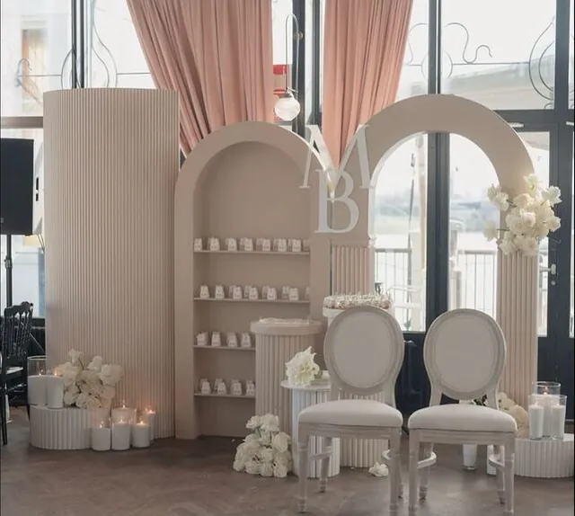 Boutique activation with arch backdrops, plinths and upholstered chairs