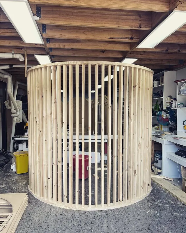 Slatted cylinder in raw board, part-built in the workshop