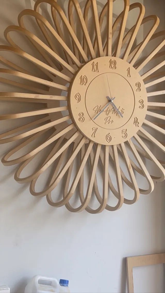Timber-look sunburst clock with radiating fluted spokes