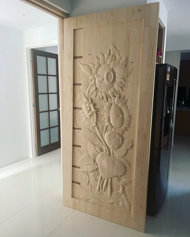 A custom door with a sunflower relief carved into its face