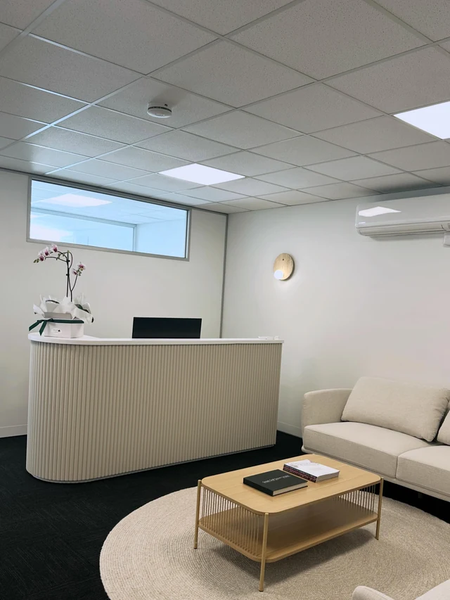 Fluted reception counter in a consulting room with a waiting area