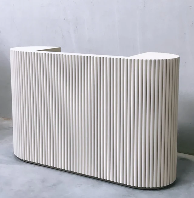 White fluted counter on a dark recessed base