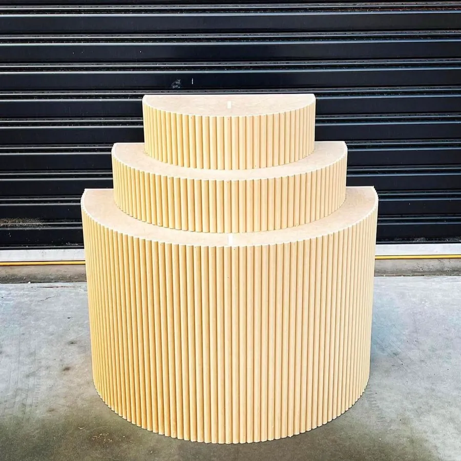 Stepped cylindrical plinths in a cream fluted finish