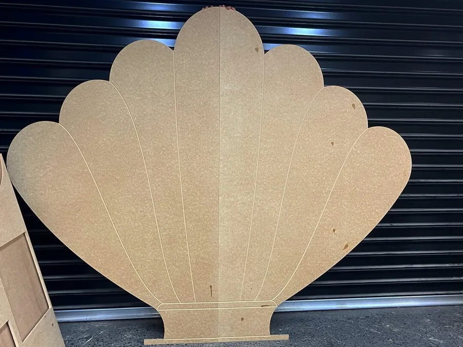 Raw MDF shell backdrop against a roller door before finishing