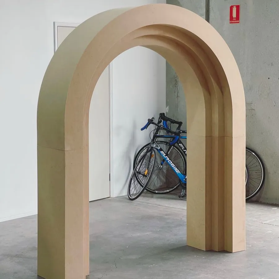 Stepped arch in a sand finish, freestanding on a polished floor