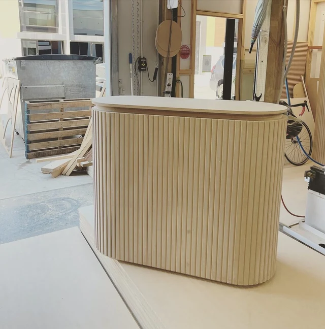 Unpainted racetrack reception counter on the workshop floor
