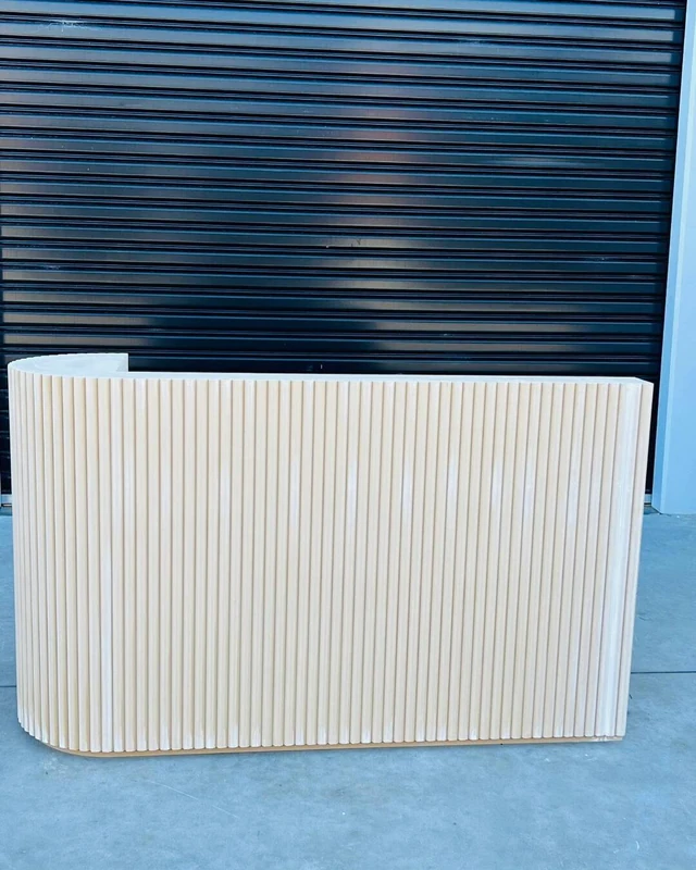 Cream fluted counter with a square return, photographed against a blue roller door