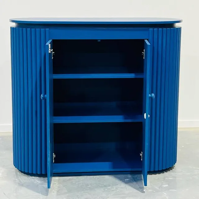Blue fluted cabinet with the doors open showing internal shelving
