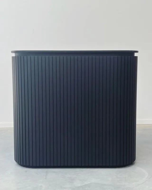Fluted reception counter finished in charcoal