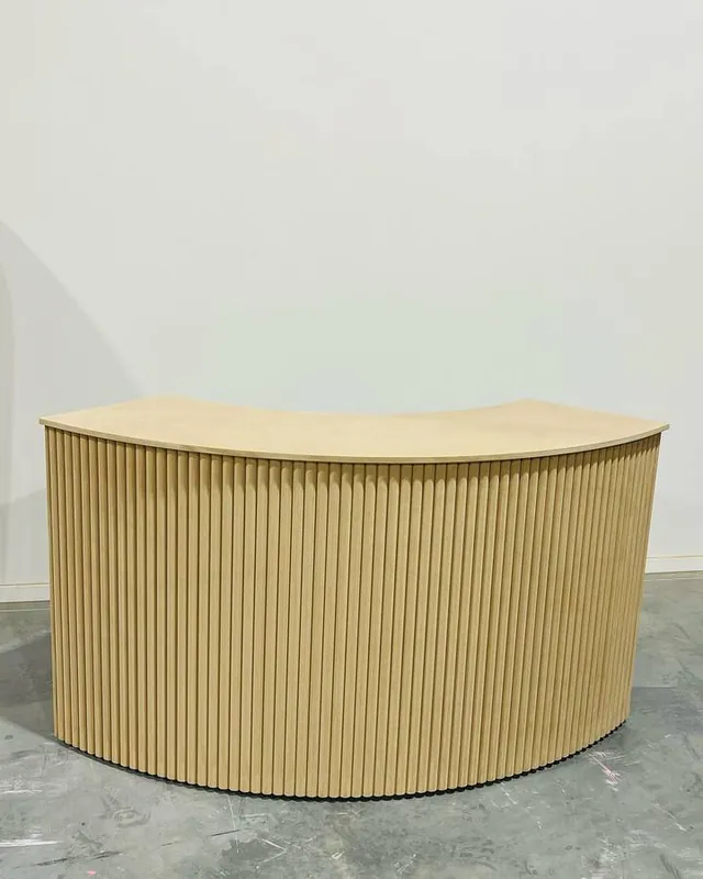 Curved fluted reception counter sprayed mustard, with a timber-look top