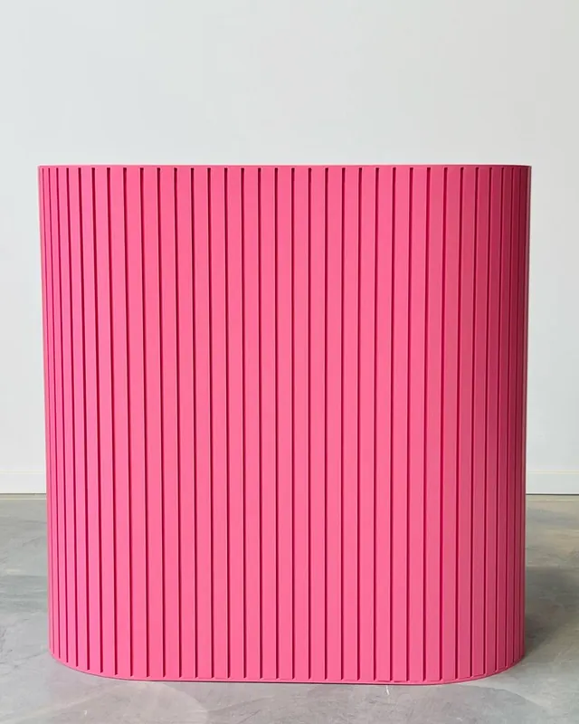 Fluted racetrack reception counter finished in hot pink
