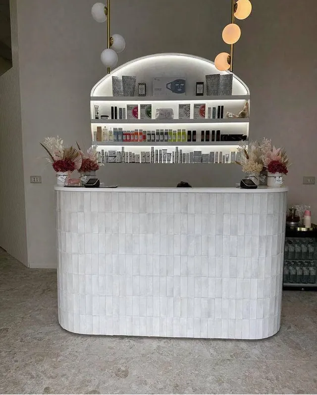 Tiled retail counter with arched display shelving above