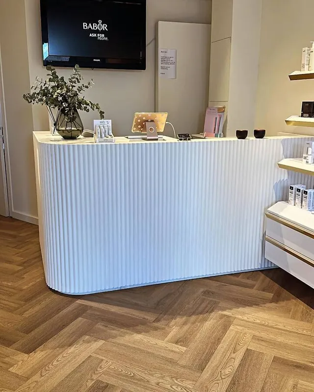 White fluted curved counter on a herringbone floor