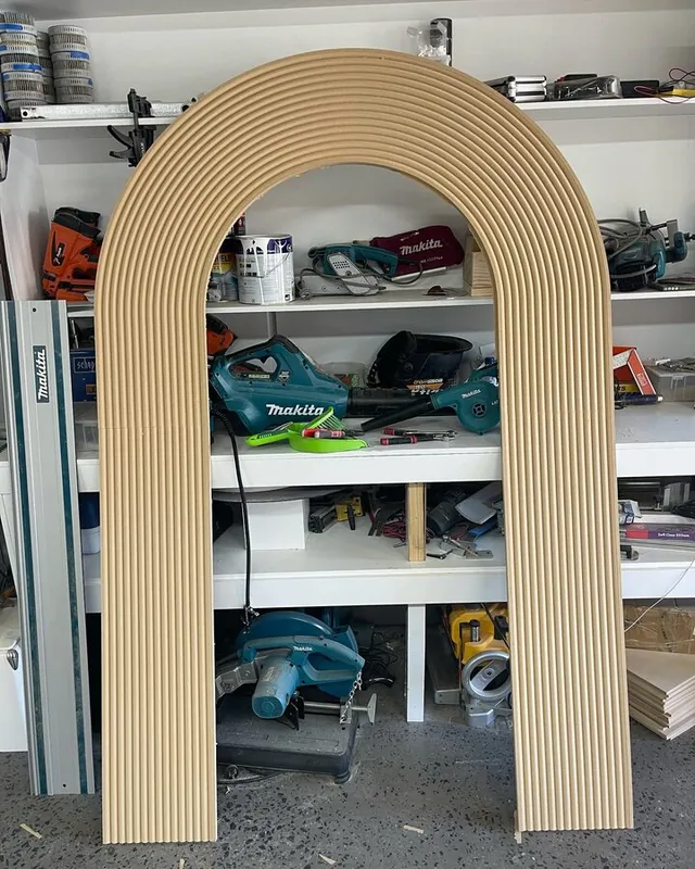 Freestanding timber-look arch shelving unit in a retail space