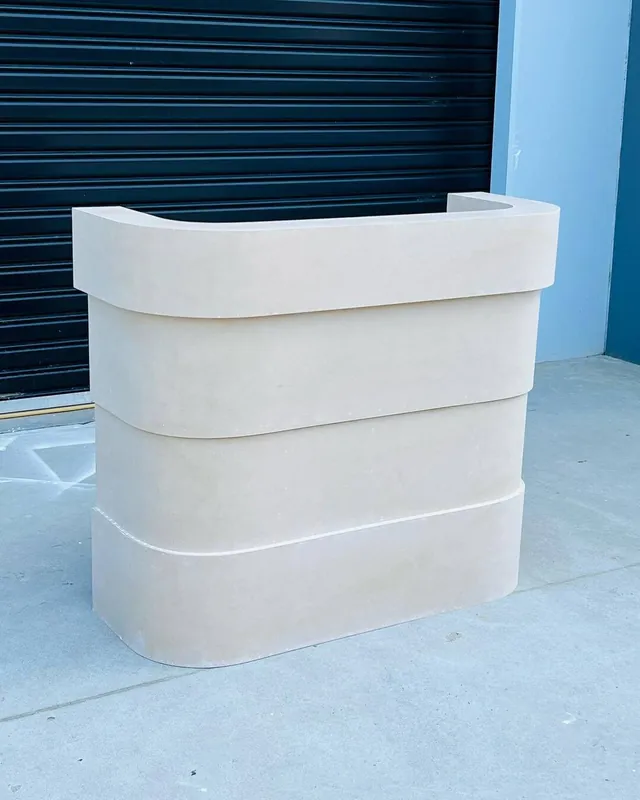 Stone coloured stepped counter photographed outside on concrete